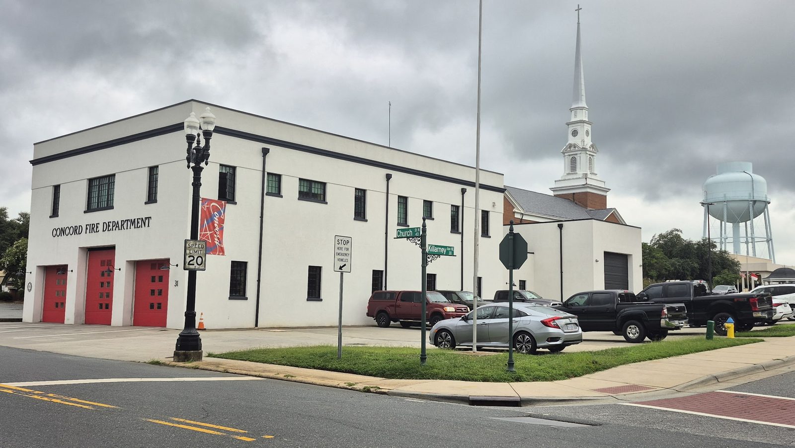 Concord Fire Department with church steeple and water tower, corner of Church St and Killarney Ave, Concord NC